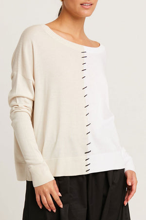 Planet Half Whipped Sweater in Stone/White.  Crew neck knit with 1/2 and 1/2 vertical color block.  Whipstitch detail in black down center front. Long sleeves with drop shoulder. Rib trim at neck.  One size fits many.  Oversized fit._61189666865518