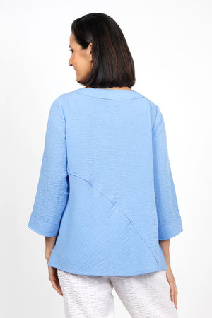 Habitat Travel Swing Tunic in Cornflower. Solid lightly crinkled top with crew neck and 3/4 sleeve. Diagonal seaming in front and back with raised edge. Swing shape. Slightly oversized fit._35123307675848