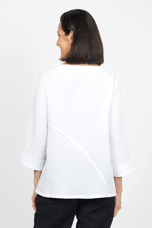 Habitat Travel Swing Tunic in White. Solid lightly crinkled top with crew neck and 3/4 sleeve. Diagonal seaming in front and back with raised edge. Swing shape. Slightly oversized fit._35123305349320