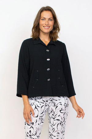 Habitat Travel Pleat Back Jacket in Black.   Spread collar button down with matching novelty buttons.  2 front angled pockets with flap detail.  3/4 sleeve. Back yoke with 3 button tab detail.  High low hem.  A line shape. Relaxed fit._35123615891656