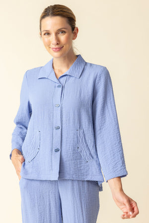 Habitat Travel Pleat Back Jacket in rain blue.  Spread collar button down with matching novelty buttons.  2 front angled pockets with flap detail.  3/4 sleeve. Back yoke with 3 button tab detail.  High low hem.  A line shape. Relaxed fit._59962226049390