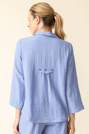 Habitat Travel Pleat Back Jacket in rain blue.  Spread collar button down with matching novelty buttons.  2 front angled pockets with flap detail.  3/4 sleeve. Back yoke with 3 button tab detail.  High low hem.  A line shape. Relaxed fit._59962226147694