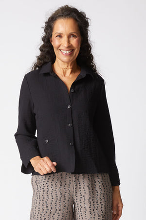 Habitat Travel Jill Shirt in Black.  Textured button down with pointed collar.  Bracelet length sleeve with split cuff.  Single front patch pocket with button closure.  Side slits. Boxy shape.  Relaxed fit._61457476813166