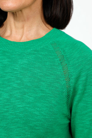 Metric Pointelle Crew Neck Sweater in kelly Green. Crew neck long sleeve sweater with raglan sleeves. Pointelle stitching at seams. Rib trim at neck, hem and cuff. Classic fit._35103948964040