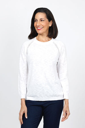 Metric Pointelle Crew Neck Sweater in White. Crew neck long sleeve sweater with raglan sleeves. Pointelle stitching at seams. Rib trim at neck, hem and cuff. Classic fit._35103948931272