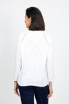 Metric Pointelle Crew Neck Sweater in White. Crew neck long sleeve sweater with raglan sleeves. Pointelle stitching at seams. Rib trim at neck, hem and cuff. Classic fit._t_35103948734664