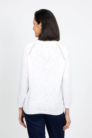 Metric Pointelle Crew Neck Sweater in White. Crew neck long sleeve sweater with raglan sleeves. Pointelle stitching at seams. Rib trim at neck, hem and cuff. Classic fit._35103948734664