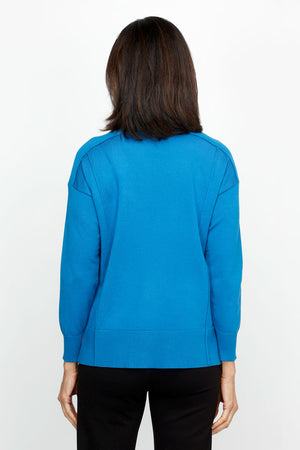 Metric Side Seam Sweater in Indigo Blue.  Square neck long sleeve sweater with dropped shoulder.  Raised seam detail at shoulders.  Off center raised seams in front and back.  Deep rib at hem and cuff. Side slits.  Relaxed fit._61376537756014