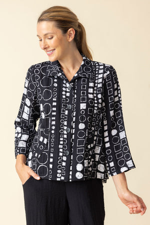 Habitat Travel Circle Pleat Back Jacket in Black with a white circle print.  Spread collar button down jacket with novelty buttons.  3/4 sleeve.  2 front angled pouch pockets with sewn flap detail.  Back  center tab with 3 button detail and soft pleating. Relaxed fit._59962933346670