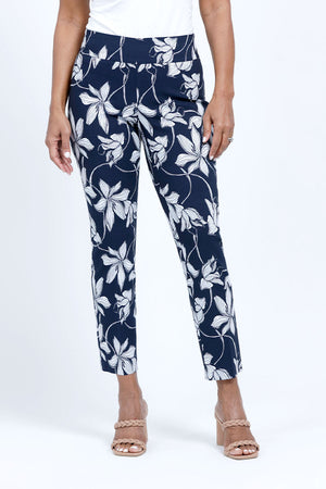 Holland ave Lilies Print Ankle Pant.  White lily print on a midnight blue background.  Pull on pant with 2 1/2" curved waistband.  Snug through hip and thigh, falls straight to hem.  28" inseam._34888831041736