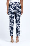 Holland ave Lilies Print Ankle Pant. White lily print on a midnight blue background. Pull on pant with 2 1/2" curved waistband. Snug through hip and thigh, falls straight to hem. 28" inseam._t_34888831008968