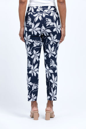 Holland ave Lilies Print Ankle Pant. White lily print on a midnight blue background. Pull on pant with 2 1/2" curved waistband. Snug through hip and thigh, falls straight to hem. 28" inseam._34888831008968