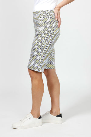 Holland Ave Yellow Geo Dot Bermuda. Black & white medallion print with yellow accents. 2 1/2" waistband with 2 front slash pockets. Pull on short. Snug through stomach and hip, slim through thigh to hem. 11" inseam._34995263799496