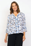 Habitat Travel Placket Shirt in Twilight.  Blue and black soft floral print on a white background.  Spread collar button down shirt with single exposed novelty button and hidden button placket.  3/4 sleeve with tulip hem.  Twilight blue piping trim on placket and cuff.  Relaxed fit._t_35135369412808