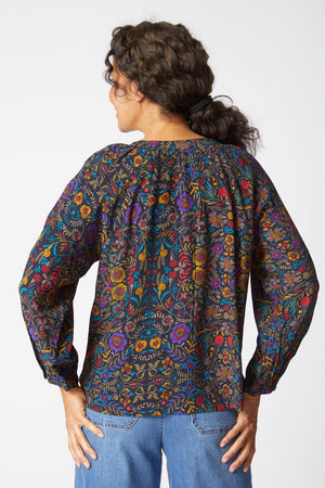 Habitat Vine Romance Shirt in Black.  Delicate multi colored floral print on black background.  Banded crew with notched v.  Button down.  Raglan bracelet sleeve with button cuff.  Side slits.  Boxy shape.  Relaxed fit._61286665683310
