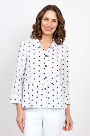 Habitat Dots Shirttail Top in White with embroidered black dots. Pointed collar button down with dropped waist seaming. Hidden front pocket with button. 3/4 sleeve with cuff. 3 button detail at lower back hem. High low hem. Relaxed fit._35420225994952