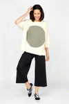 Planet ORB T in Butter with a large Green screen print circle in front. Crew neck with drop shoulder and 3/4 length sleeve. High low hem. Oversized fit. Pair with Spa Gaucho in Black_t_60432418308462