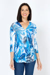 Top Ligne Leaves Button Back Top.  Tropical leaves pattern in blue with touches of brown on white.  V neck with faux 2 button placket.  3/4 sleeve.  Back yoke with center back buttons.  Curved high low hem.  Relaxed fit._t_59777464435054