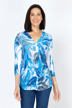 Top Ligne Leaves Button Back Top.  Tropical leaves pattern in blue with touches of brown on white.  V neck with faux 2 button placket.  3/4 sleeve.  Back yoke with center back buttons.  Curved high low hem.  Relaxed fit._59777464435054