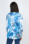 Top Ligne Leaves Button Back Top.  Tropical leaves pattern in blue with touches of brown on white.  V neck with faux 2 button placket.  3/4 sleeve.  Back yoke with center back buttons.  Curved high low hem.  Relaxed fit._t_59777464467822