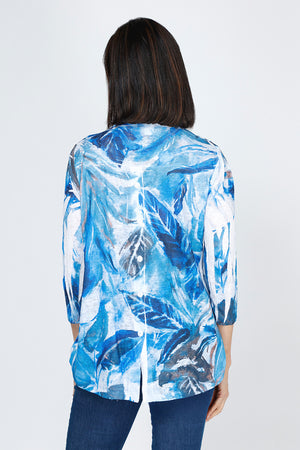 Top Ligne Leaves Button Back Top.  Tropical leaves pattern in blue with touches of brown on white.  V neck with faux 2 button placket.  3/4 sleeve.  Back yoke with center back buttons.  Curved high low hem.  Relaxed fit._59777464467822