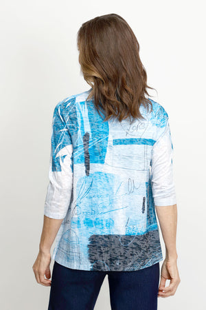 Top Ligne Abstract Scribbles Cardi Set in Multi.  Shades of blue and black 2 piece set with screen print tank top and open front matching cardi.  Cardigan has 3/4 sleeve and mesh insets with sequin detail at the sides.  Sleeveless crew neck tank.  Cardi is longer than the tank.  Relaxed fit._61430998466926