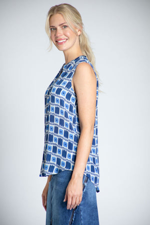 APNY Dot That Sleeveless Blouse in Blue. Block print with dots and stripes in shades of blue and white. Sleeveless banded collar button down blouse. A line shape. Curved hem. Relaxed fit._35227691745480