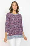 Habitat Travel Knit Pleat Back Tunic in Melon.  Navy rimmed white dots on an orange background.  Crew neck 3/4 sleeve a line top with complentary blue  stick print on a white background.  Pleat detail in back.  Relaxed fit._t_35285596930248