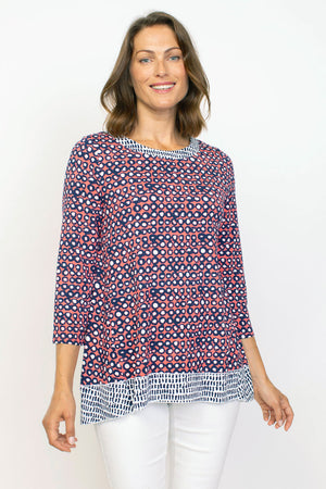 Habitat Travel Knit Pleat Back Tunic in Melon.  Navy rimmed white dots on an orange background.  Crew neck 3/4 sleeve a line top with complentary blue  stick print on a white background.  Pleat detail in back.  Relaxed fit._35285596930248
