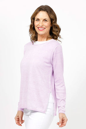 Elliott Lauren Double Layer Sweater in Wisteria, a light purple. Tee shirt/knit combo. Crew neck sweater with white trim at neck and armhole seams. Long sleeves and side slits. White cotton tee underlayer. Unlined sleeves. Relaxed fit._35067861434568