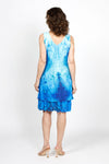 Top Ligne Watercolor Speckles Dress in Blue. Speckled watercolor print in shades of blue. Sleeveless v neck dress with 2 attached layers. Bottom layer has attached ruffle at hem. Top shorter layer. Relaxed fit._t_35408815685832