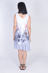 Top Ligne Poppy Flowers Flounce Dress in White with red poppys on a black and white field. 2 layer sleeveless v neck dress. Longer layer has attached ruffle at hem. Top layer is shorter to allow ruffle to peek through. Relaxed fit._t_34245607915720