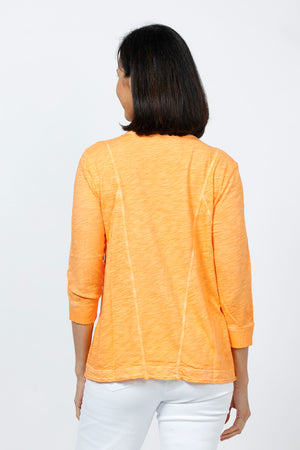 Elliott Lauren V Neck Seam Detail Tee in Tiger Lily, a light orange. V neck garment dyed 3/4 sleeve top. Wrapped contour seams from front to back. Asymmetric hem. Rib detail at neck hem and cuff. Relaxed fit._35201251377352