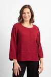 Habitat Pattern Play Pocket top in Cranberry.  Textured crew neck top with cuffed 3/4 sleeve.  Center front lapped seam. Front hem insert with inset pockets.  Plain back.  Fringed edges at neck, cuff, front seam and pockets.  A line shape.  Relaxed fit._t_34550937026760
