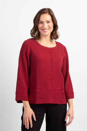 Habitat Pattern Play Pocket top in Cranberry.  Textured crew neck top with cuffed 3/4 sleeve.  Center front lapped seam. Front hem insert with inset pockets.  Plain back.  Fringed edges at neck, cuff, front seam and pockets.  A line shape.  Relaxed fit._34550937026760