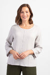 Habitat Pattern Play Pocket top in Putty. Textured crew neck top with cuffed 3/4 sleeve. Center front lapped seam. Front hem insert with inset pockets. Plain back. Fringed edges at neck, cuff, front seam and pockets. A line shape. Relaxed fit._t_34656760692936