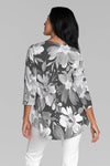 Whimsy Rose Festive Bloom Flowy Tunic in Black Multi. White and gray large floral print on a black background. V neck 3/4 sleeve a line tunic tee with a curved hem. Relaxed fit._t_35279884615880