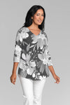 Whimsy Rose Festive Bloom Flowy Tunic in Black Multi.  White and gray large floral print on a black background.  V neck 3/4 sleeve a line tunic tee with a curved hem.  Relaxed fit._t_35279884779720