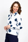 Elliott Lauren Sand Dollar Blouse in White with dark blue sand dollar print. Pointed collar button down long sleeve blouse with button cuff. High low hem. Side slits. Relaxed fit._t_35419568046280