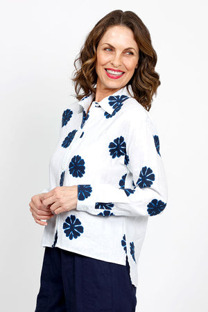 Elliott Lauren Sand Dollar Blouse in White with dark blue sand dollar print. Pointed collar button down long sleeve blouse with button cuff. High low hem. Side slits. Relaxed fit._35419568046280