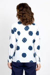 Elliott Lauren Sand Dollar Blouse in White with dark blue sand dollar print. Pointed collar button down long sleeve blouse with button cuff. High low hem. Side slits. Relaxed fit._t_35419568079048
