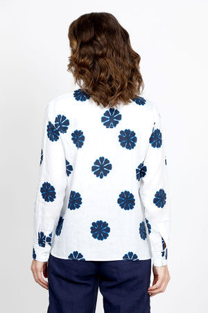 Elliott Lauren Sand Dollar Blouse in White with dark blue sand dollar print. Pointed collar button down long sleeve blouse with button cuff. High low hem. Side slits. Relaxed fit._35419568079048