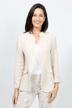 Organic Rags Fringed Linen Jacket in Taupe. Open front banded collar jacket. Long sleeves with elbow patch detail. Faux front flap pockets. Contour seams. Fringed edges at collar and hem._34995340181704