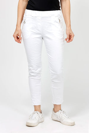 Organic Rags Raw Hem Pull On Pant in White.  Elastic waist pant.  2 front zip pockets with silver zipper trim.  Slim leg.  Raw hem.  Inseam: 27 1/2"_52912166797678