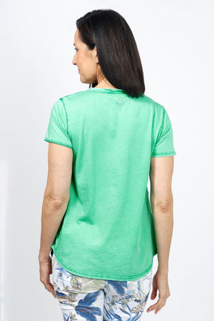 Organic Rags Happy V Neck Tee in Apple Green. V neck short sleeve top with raw edge at banded neckline. Slightly faded wash. Smiley face embroidered at back neckline. Relaxed fit._34960621043912