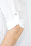 Organic Rags Roll Tab Sleeve Top in White.  Modified scoop neck with 2 button placket and pin tucks at front neckline.  3/4 sleeve with roll button tab.  High low hem.  Relaxed fit._t_59972845470062