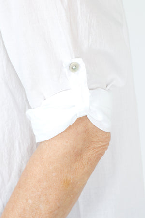 Organic Rags Roll Tab Sleeve Top in White.  Modified scoop neck with 2 button placket and pin tucks at front neckline.  3/4 sleeve with roll button tab.  High low hem.  Relaxed fit._59972845470062