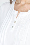 Organic Rags Roll Tab Sleeve Top in White.  Modified scoop neck with 2 button placket and pin tucks at front neckline.  3/4 sleeve with roll button tab.  High low hem.  Relaxed fit._t_59972845568366