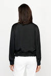 Lolo Luxe Washable Silk Zip Jacket in Black.  Banded ribbed crew neck with zip front and silver sipper.  Long sleeves with ribbed cuff.  Banded hem with adjustable drawstring.  Relaxed fit._t_61252024271214