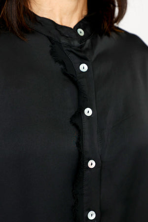Lolo Luxe Washable Silk Button Down in Black.  Banded crew neck button down with 3/4 sleeve and cuff.  Fringed chiffon raw edge trim at right placket and on cuff.  High low hem.  Relaxed fit._61251999695214
